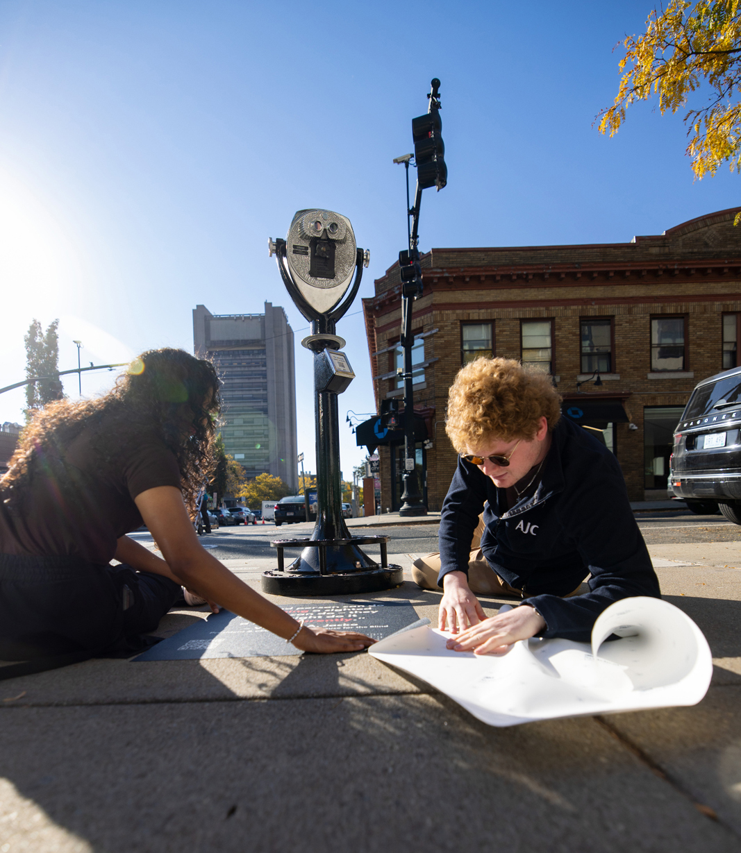 Rishika Kartik, left, and Daniel Solomon, put finishing touches on the installation.