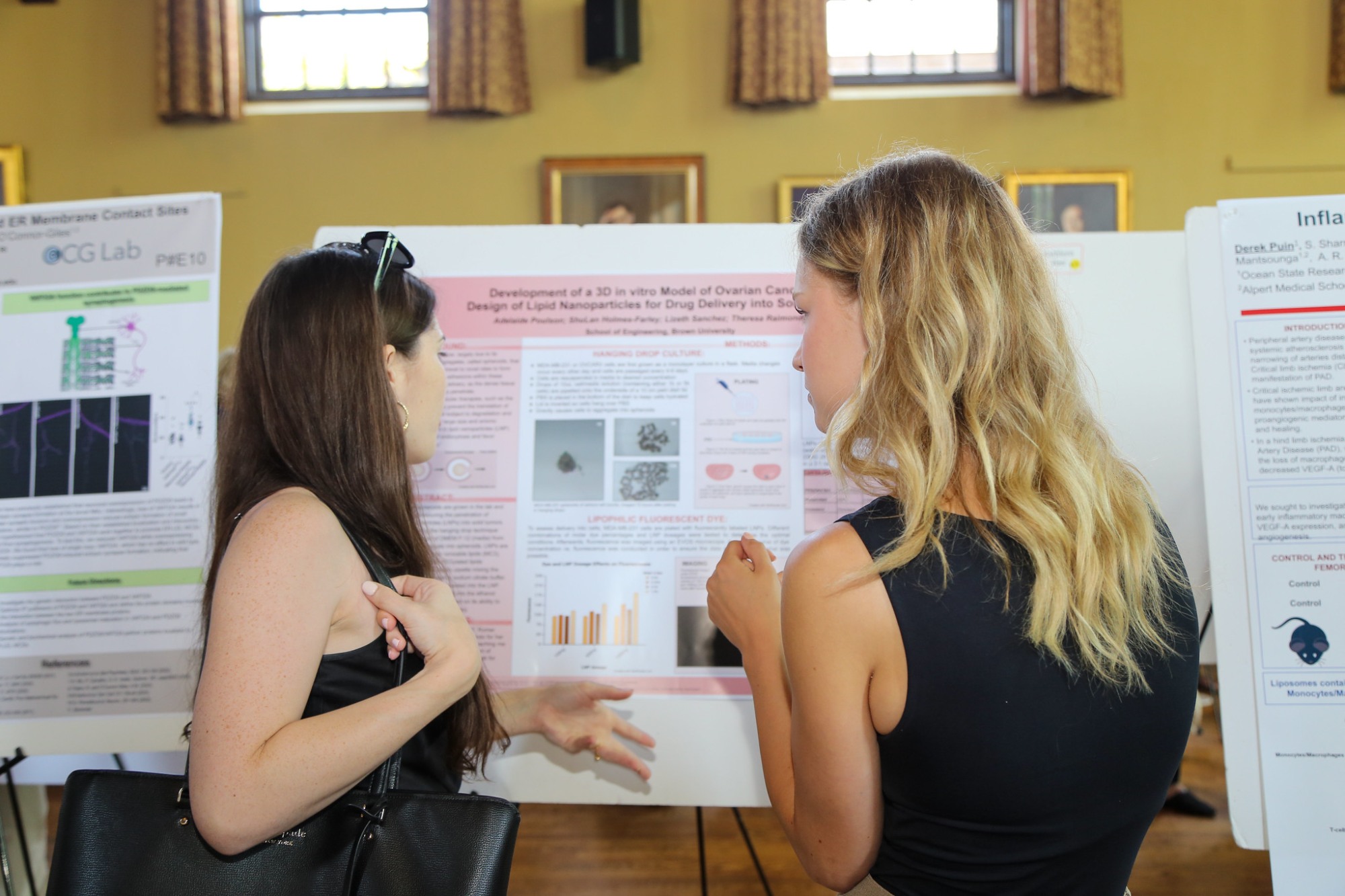 Students discuss research at an easel