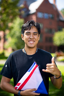 jacob holds a folded hawaiian flag