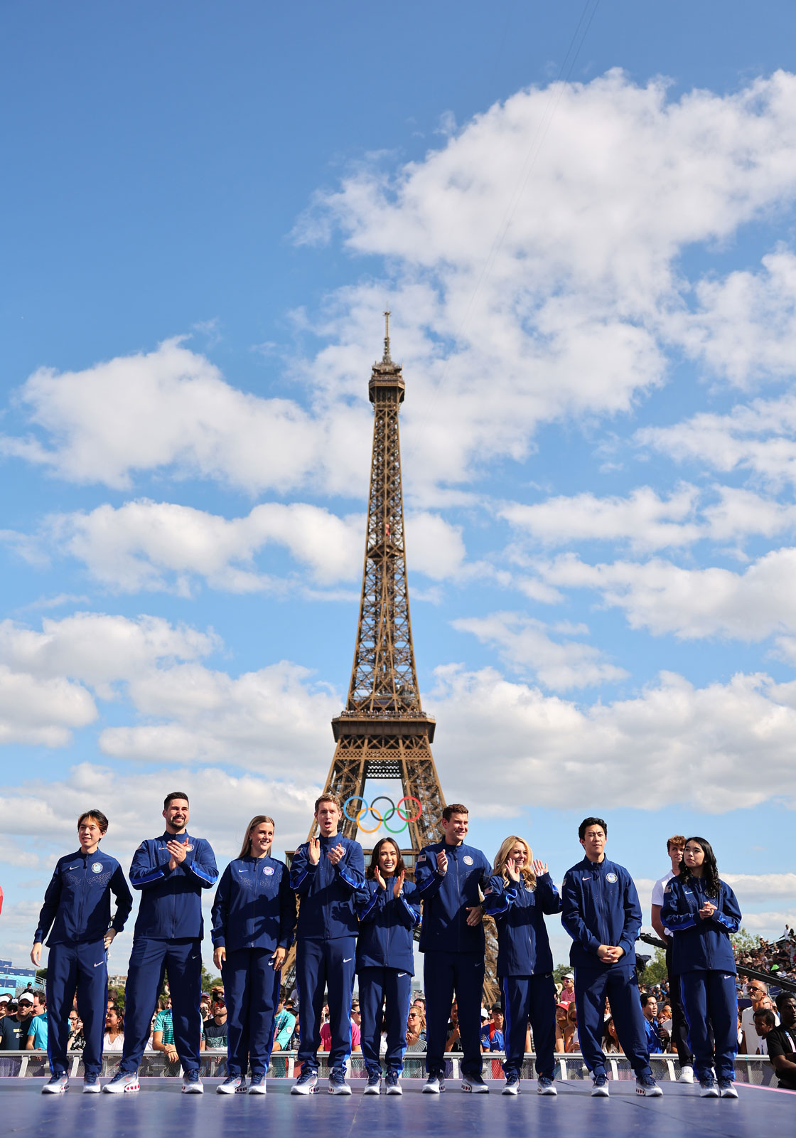 Us figure skating team accepts gold medals under the eiffel tower