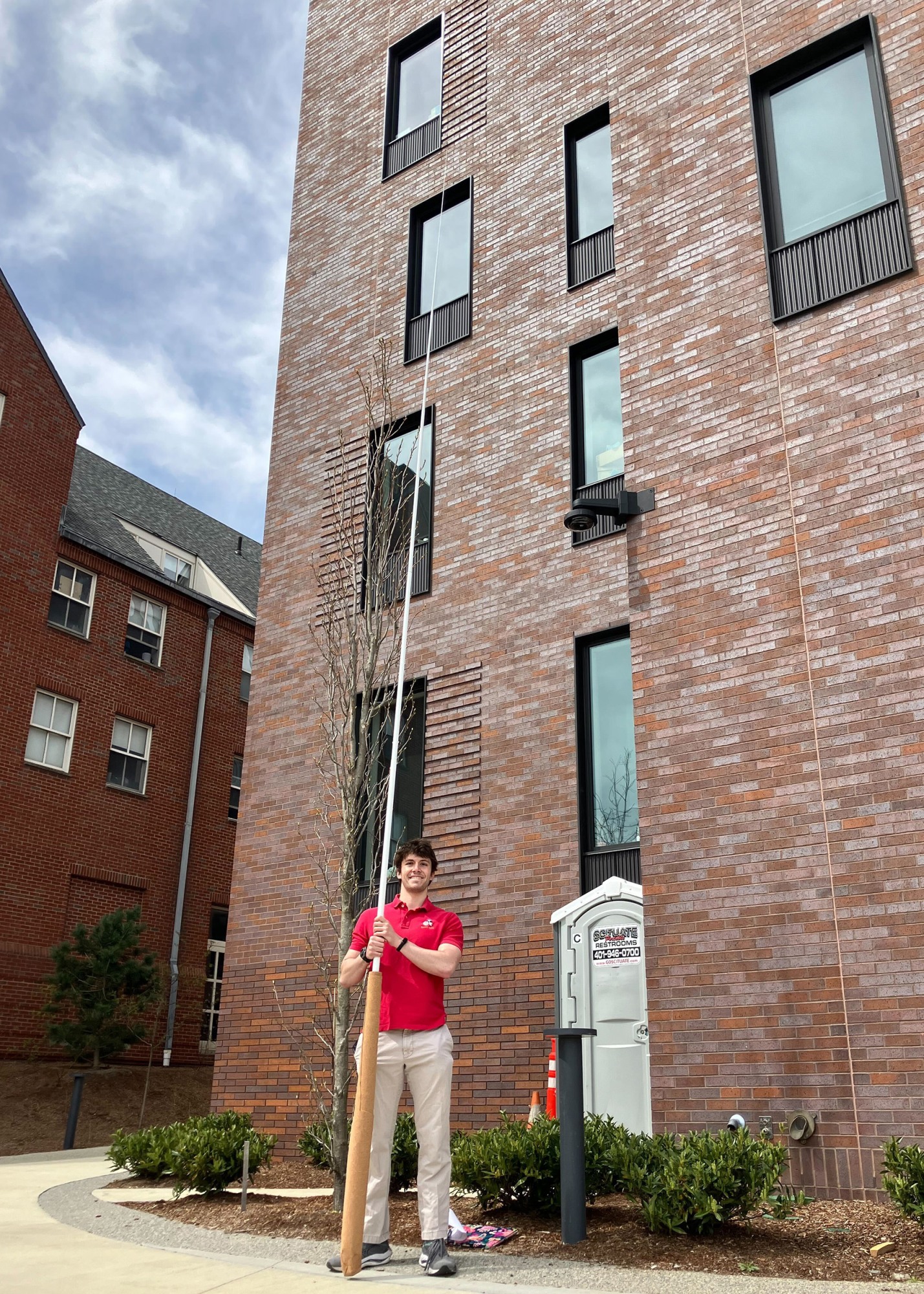 Joshua Lobsenz holds a giant baton