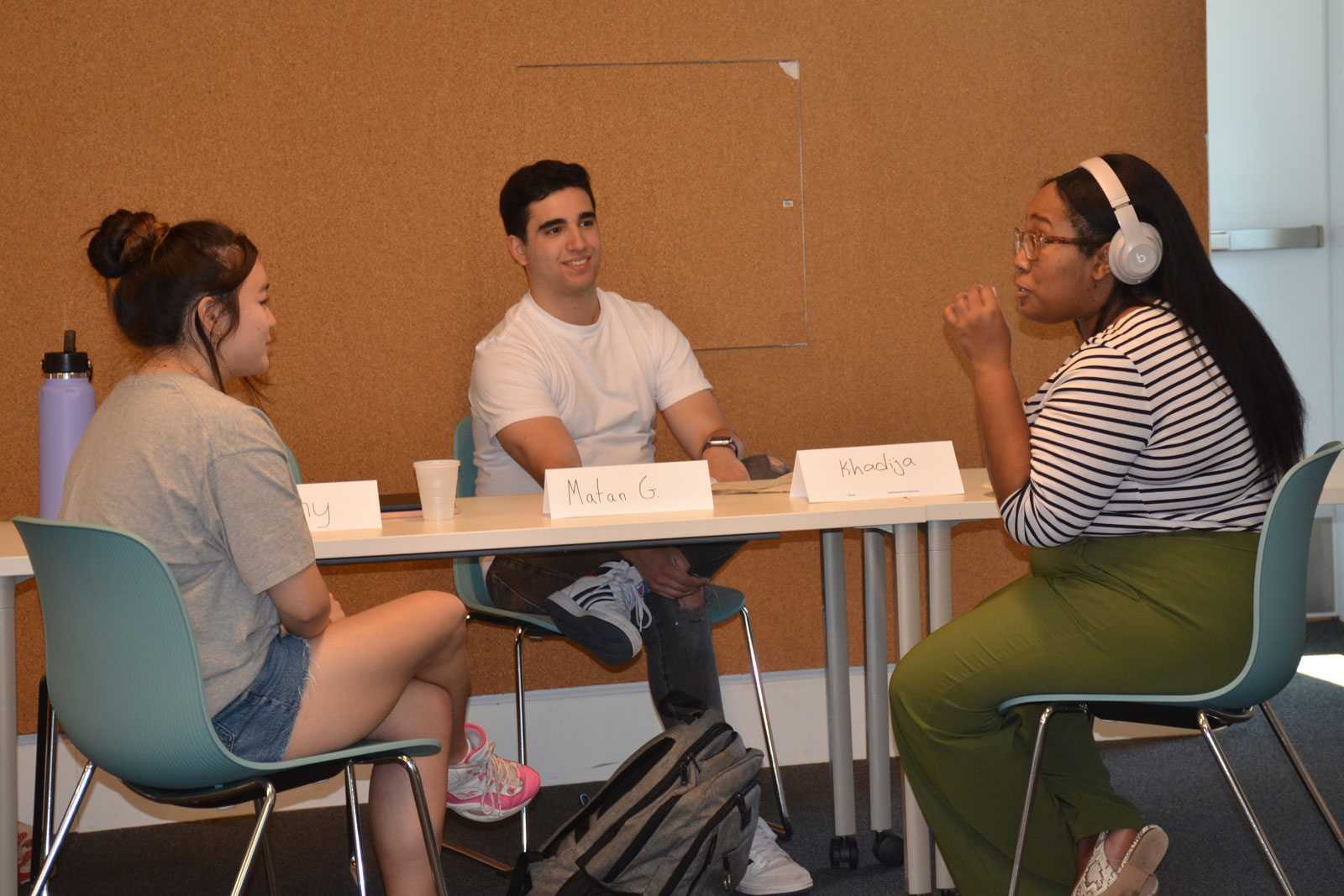 Students brainstorm around a table