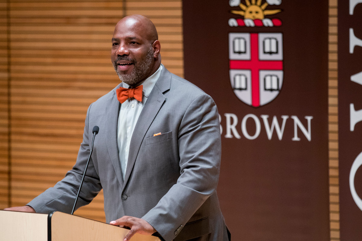 Jelani Cobb wearing red bow tie speaking at podium