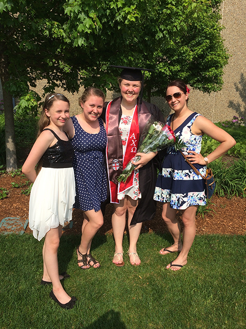 Sophia Bonenfant in grad cap and gown with her three sisters