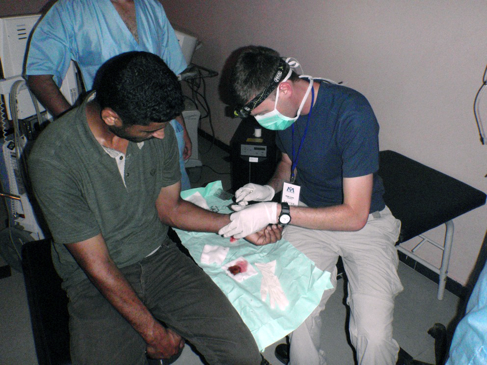 Levine working on the arm of a patient in Misrauta, Libya