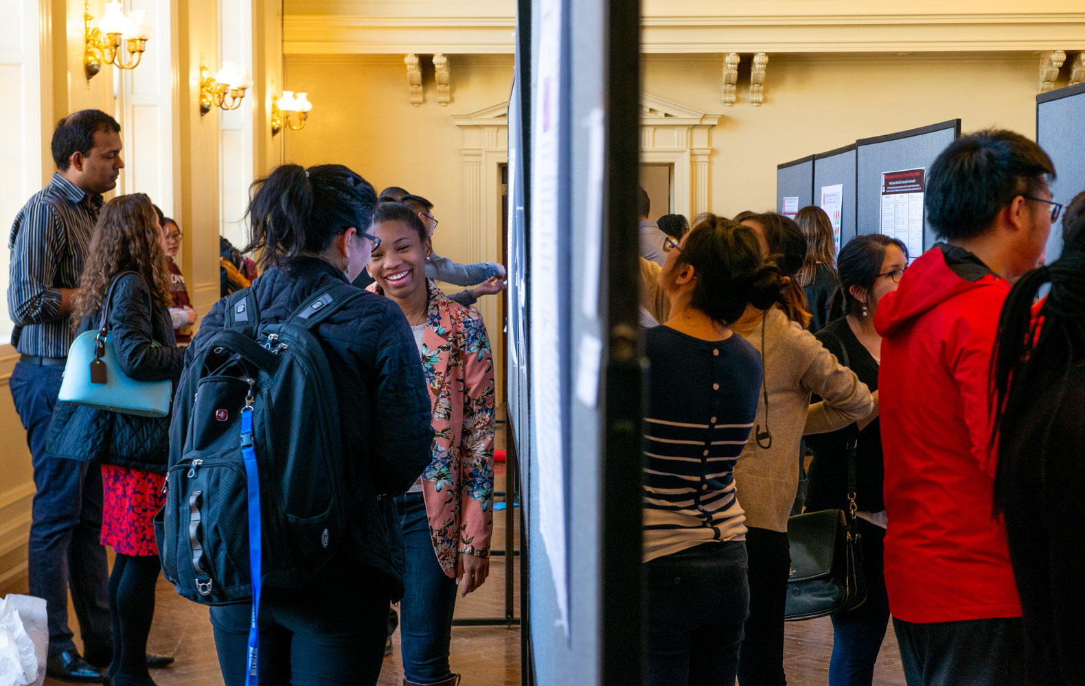 A crowd of public health researchers share their work.