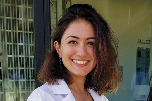 Lilit Grigoryan smiling in a lab coat