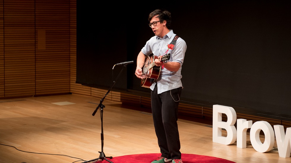 Julian Saporiti playing guitar on stage