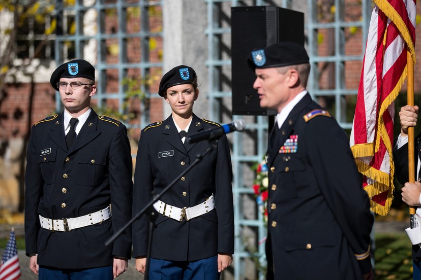 Caleb Walters and Catherine Carignan on outdoor stage wearing dress blues