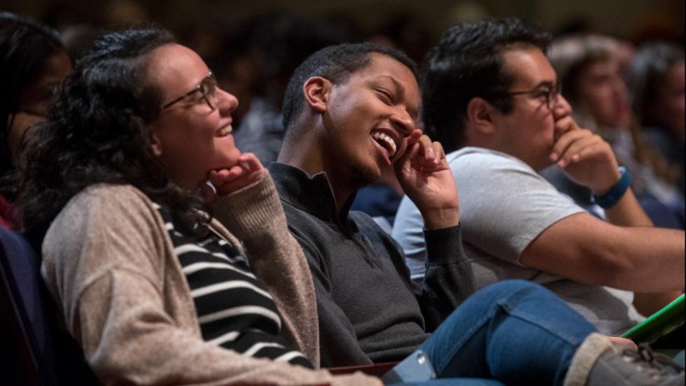 Audience members laughing