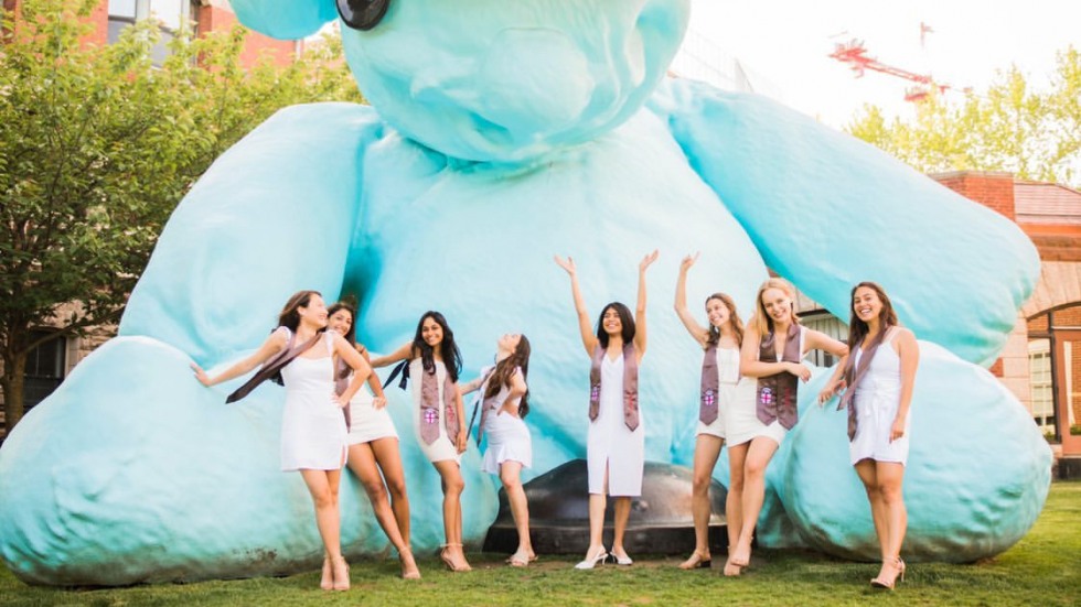 women standing in front of Blueno