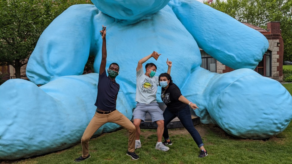 three men with masks in front of Blueno