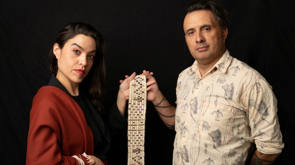 Michelle Cook and Hartman Deetz holding a wampum belt