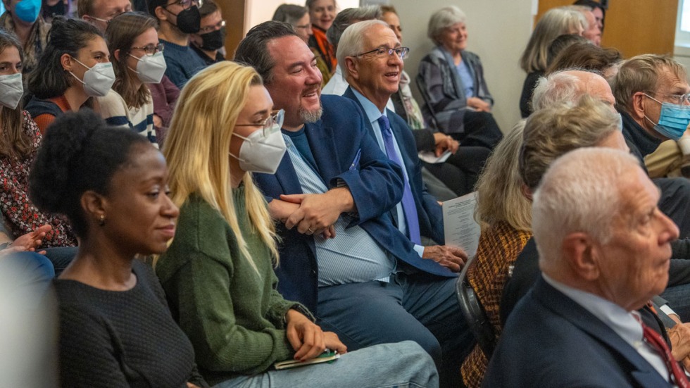 people sitting in an audience and smiling