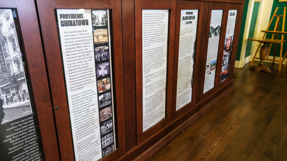 informational panels displayed behind glass and wooden bookshelves