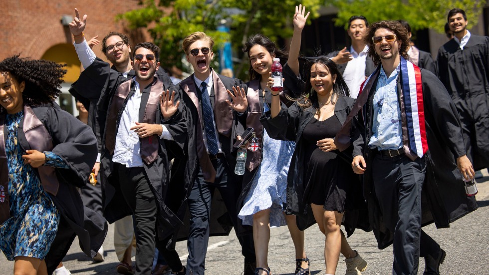 Smiling students greet the camera