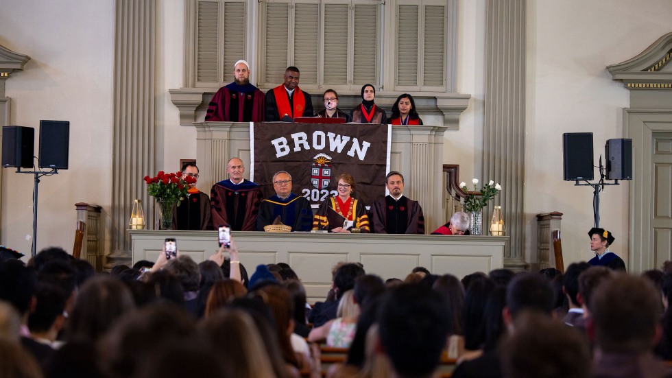 University and faith leaders sit at the pulpit