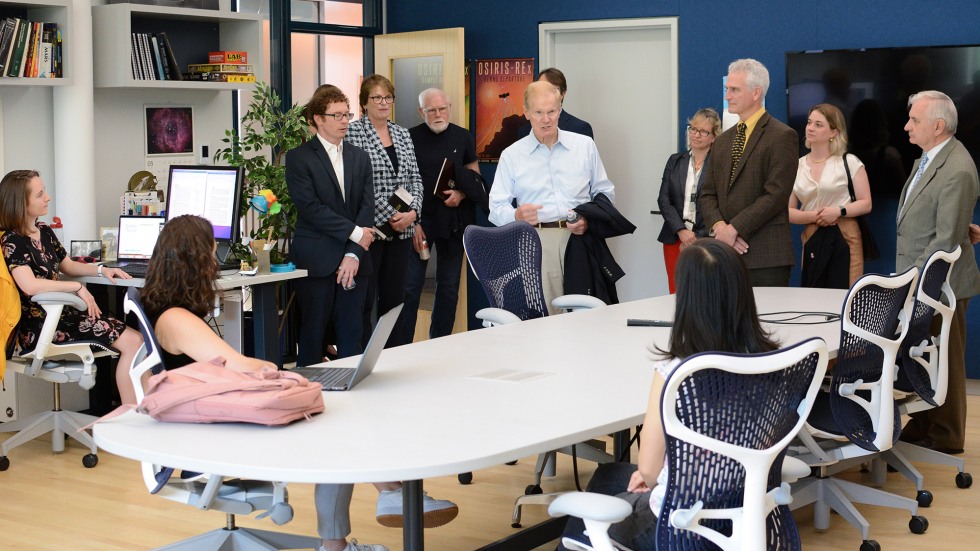 Nelson speaking with researchers