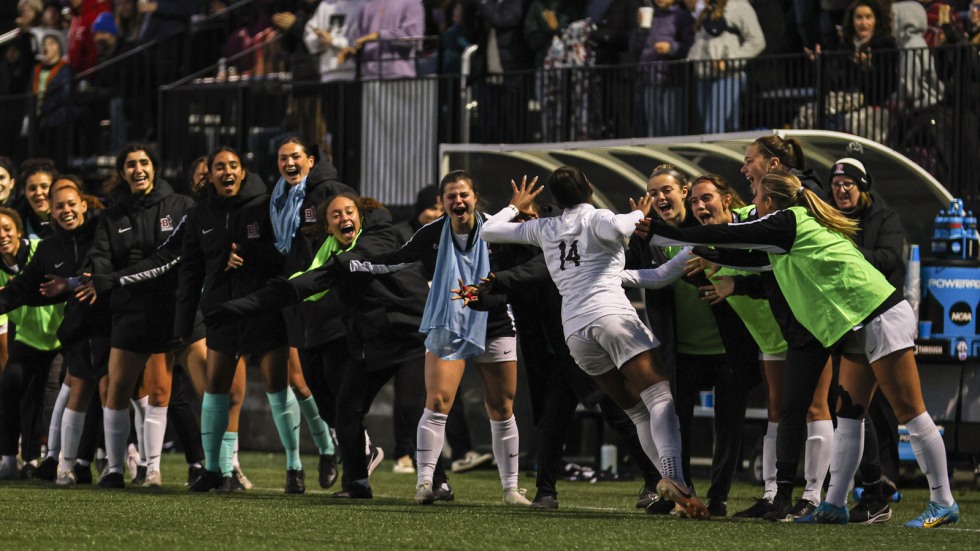 Layla Shell gives high-fives on field sidelines