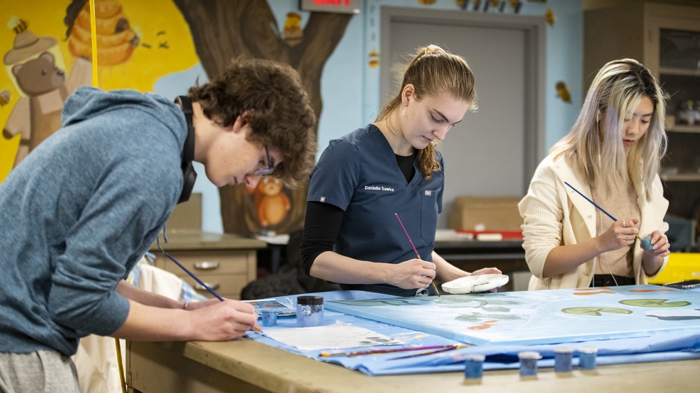 Three Brown students paint mural 