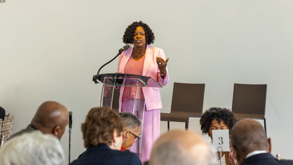 Sylvia Carey-Butler speaks at podium