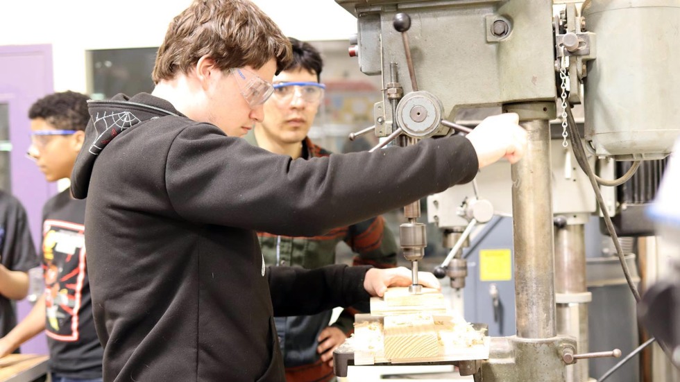 Blackstone Academy student practices using a drill press