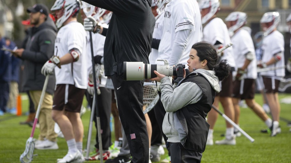 Providence high schooler taking photos of Men's Lacrosse team at Brown