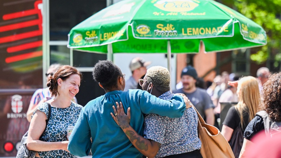 people embrace on College Green