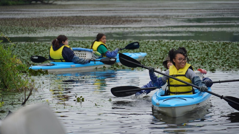 students kayak on the Blackstone River