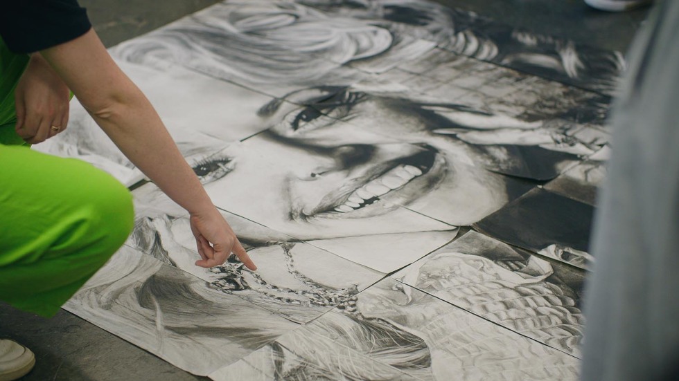 instructor points to large drawing instructing students on technique