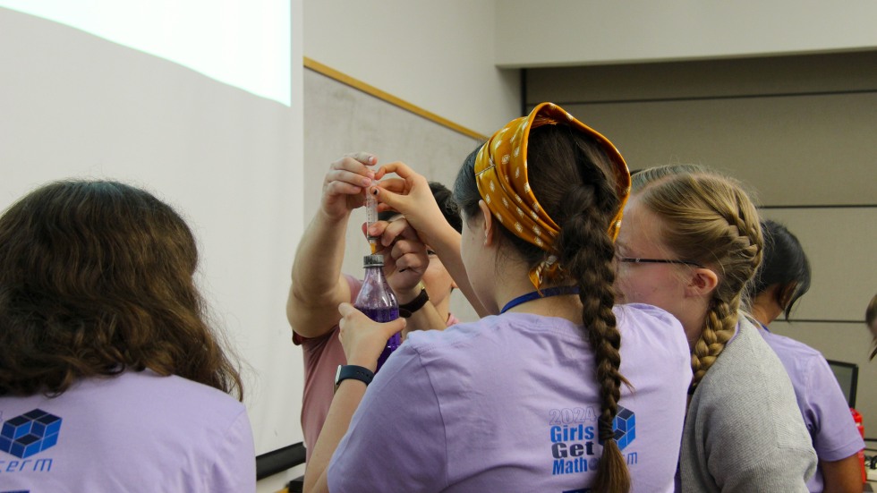 Students injecting material into a bottle