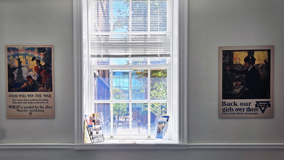 wartime propaganda posters on either side of a window