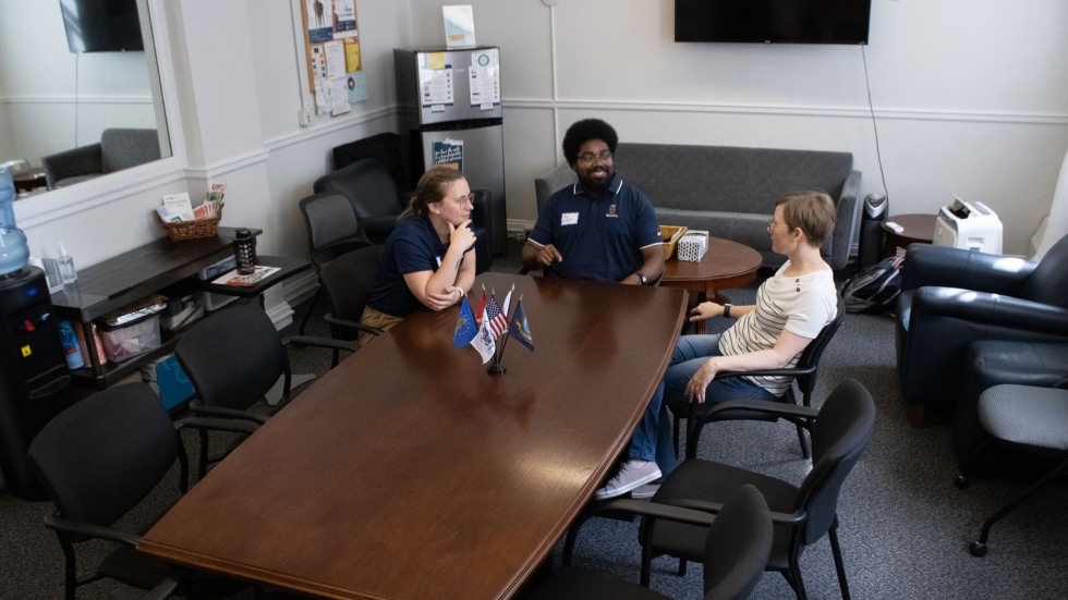 students sit at table in lounge area