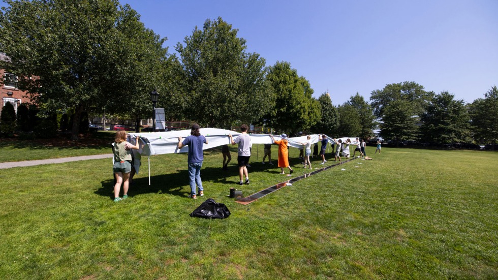 group lifts and moves shade structure