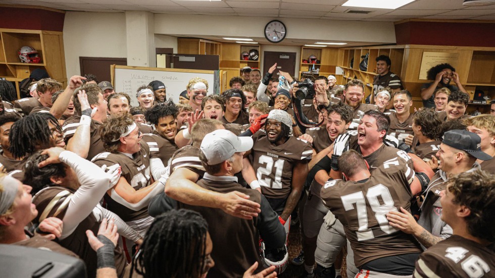 Brown Football team celebrates in locker room after win against Cornell