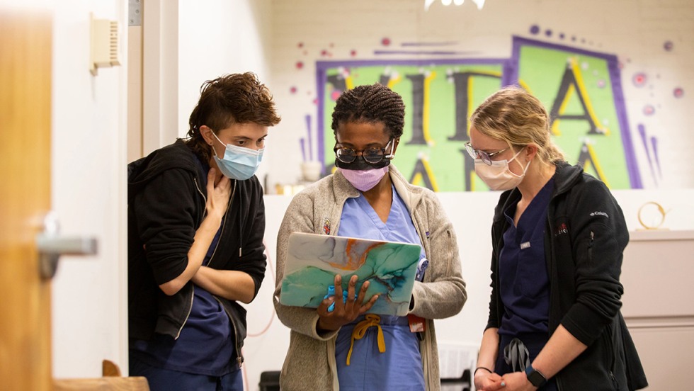 Brown medical students work in local clinic