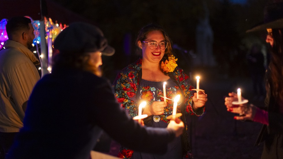 city cemetery director Annalisa Heppner hands out candles