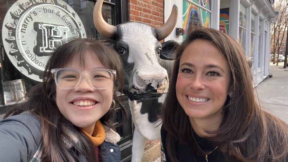 Le Yi Toh and Toni Molinari pose for a selfie in front of a cow statue