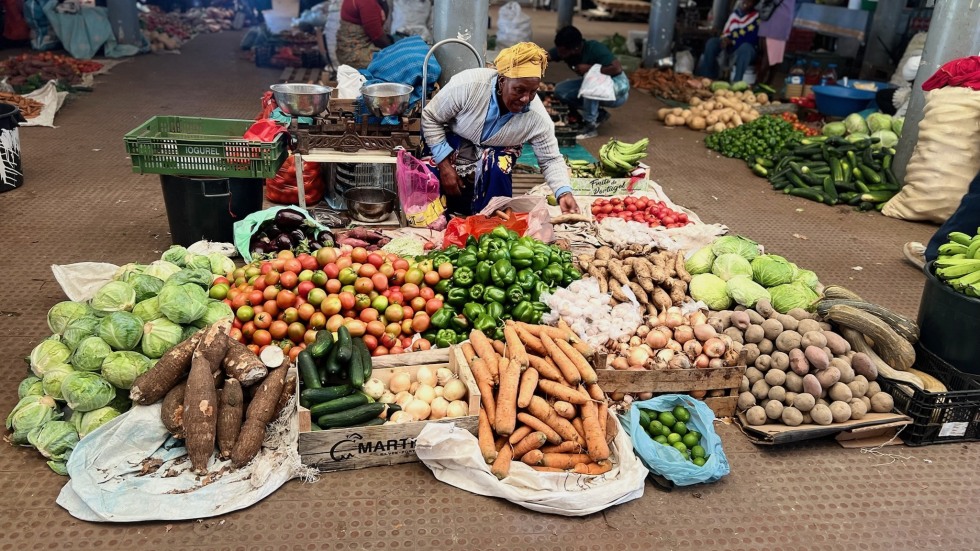 woman sells produce in market