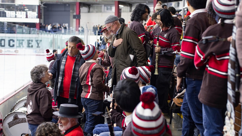 band members and alumni gather in stands 